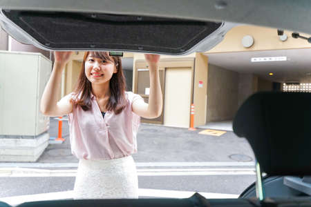Woman opening the trunkの写真素材