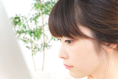 Young woman caring for skin problemsの写真素材
