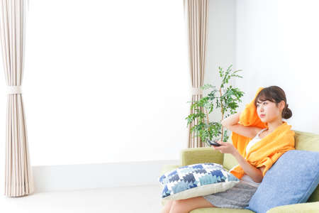 Woman watching TV at homeの写真素材
