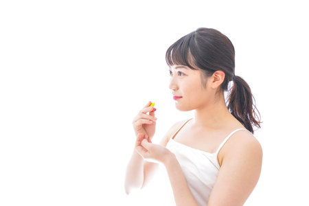 Young woman taking medicine