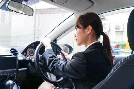 Young business woman in carの写真素材