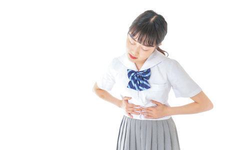 Young woman having stomach ache shot in the studio on white background