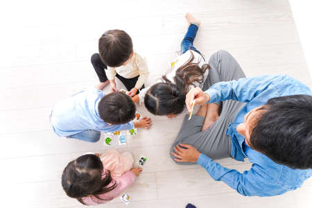 Top view of a group of children playing board games together at homeの写真素材