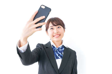 high-school girl making a video-phone callの写真素材