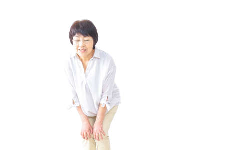 Aged woman suffering from pain in kneeの写真素材