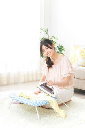Young woman doing the ironingの写真素材