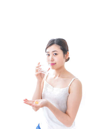Woman taking supplementの写真素材