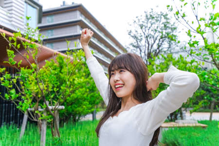 Young woman stretching in the gardenの写真素材
