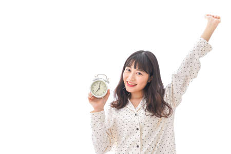 Women wake up from a good sleep in bed roomの写真素材