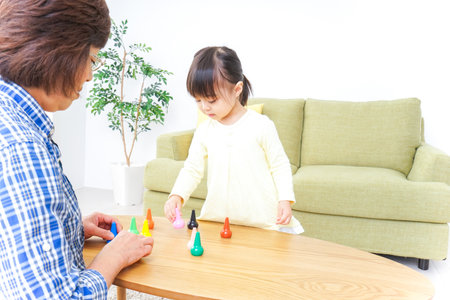 Child playing a game with grandmotherの写真素材