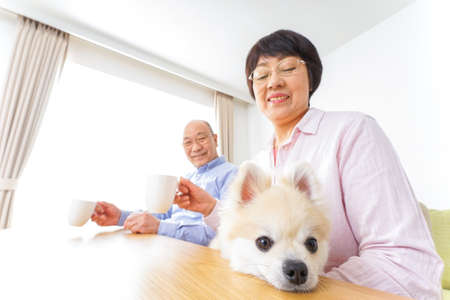 Aged couple being relaxed at homeの写真素材
