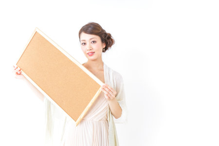 woman in dress having a cork boardの写真素材
