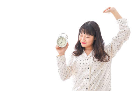 Women wake up from a good sleep in bed roomの写真素材