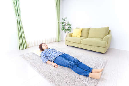 Eldery woman sleeping in roomの写真素材