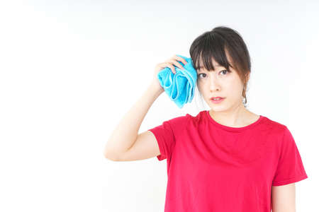 Young woman drying the sweat during sportの写真素材