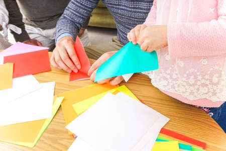 Child folding origami paperの写真素材