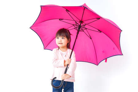 A child opening an umbrellaの写真素材