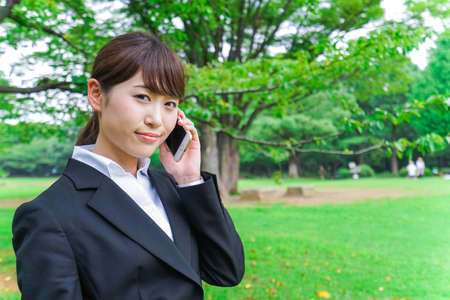 Business woman calling outsideの写真素材