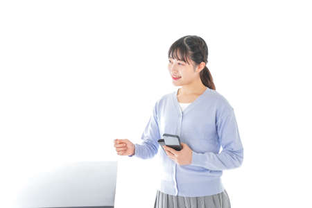 Young woman paying with digital moneyの写真素材