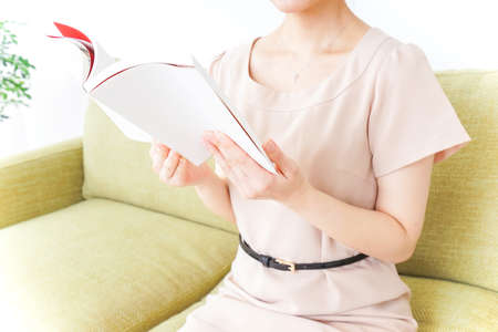 woman reading books in roomの写真素材