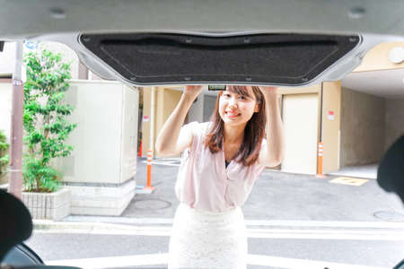 Woman opening the trunkの写真素材