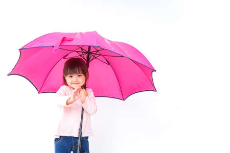 A child opening an umbrellaの写真素材