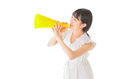 Young woman shouting into a megaphoneの写真素材