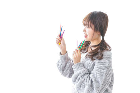 Woman having  multicolored pencilの写真素材