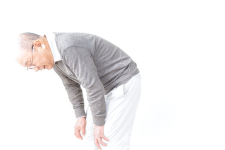 Aged man suffering from pain in kneeの写真素材