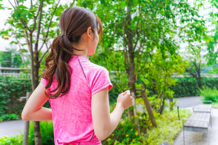 Woman running in the cityの写真素材