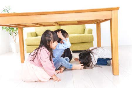 Mother and children playing on the floor in the living room high quality photoの写真素材