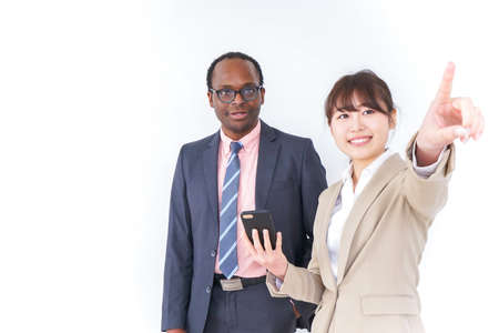 Businesspersons searching location by smartphoneの写真素材