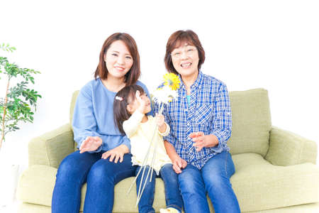 Child giving grandmother a flowerの写真素材