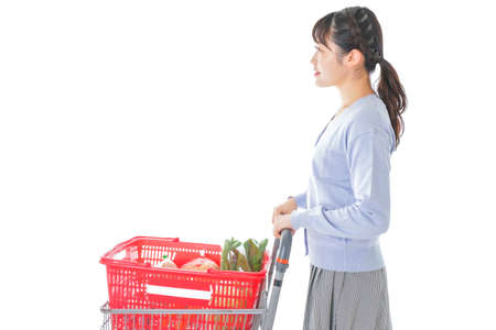 Young woman shopping at supermarketの写真素材