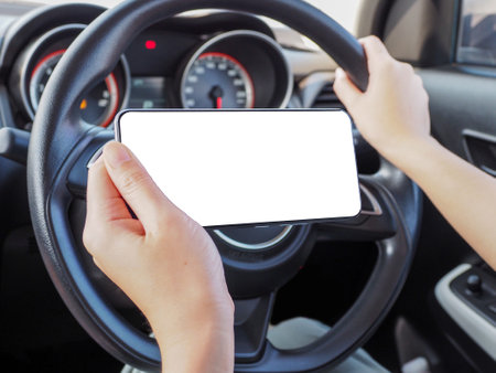 woman using phone while driving with one handの写真素材