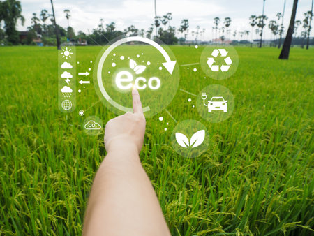 Environmental technology concept. Eco technology pointing. Connecting technology to save the earth. Green background. ECO icon is bright.の写真素材