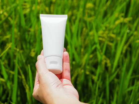 white skin care cream tube nature background green rice field Gentle on the skin, face and body care natural extractsの写真素材