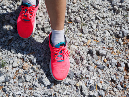 Athlete running on gravel from the top viewの写真素材