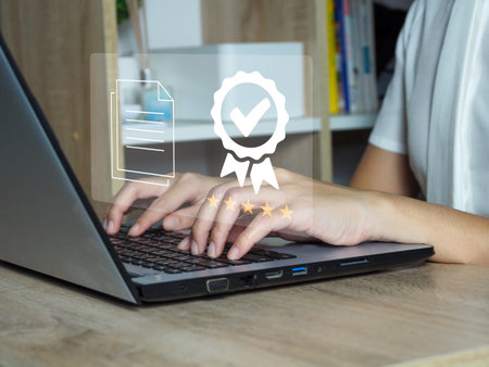 Young businesswoman using laptop showing virtual window ISO standard quality control with detailed quality content documents ISO Certificationの写真素材