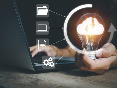 businessman holding a light bulb cloud technology on the light bulb connecting new ideasの写真素材