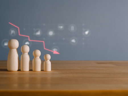 Man made of wood with a falling graph. Global financial crisis. The performance of the team is deteriorating. The readiness of the team that is going into recession.の写真素材