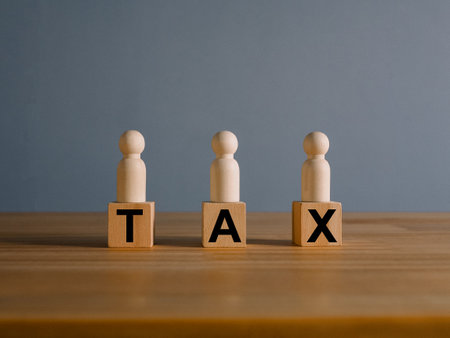 Tax concept with rising wooden blocks Expenses that are running higher than incomeの写真素材
