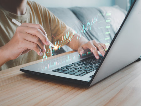 Businessman analyzing graphs with a pen financial stock market profit indicators long-term profitability on the virtual windowの写真素材