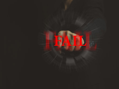 businessman hand punching Come to the red fail letter. Overcoming failure. fighting the problemの写真素材