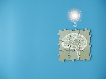 Brain on a jigsaw puzzle with bulb ideas Searching for new ideas in business on a blue backgroundの写真素材