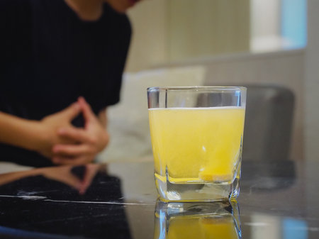 water soluble effervescent tablets Anti-flatulence pills. Multivitamin. Blurred background, man having stomach ache.の写真素材