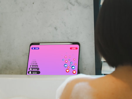 young asian woman watching Live streaming via Tab Lab while soaking in the bathtub. Watching the sale of products onlineの写真素材