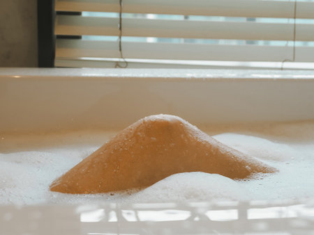 Female legs in bath foam who are enjoying and relaxing From infusion work to skin care spaの写真素材