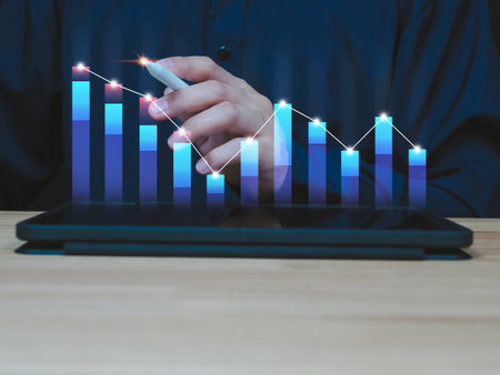 man showing business analysis financial investment Analyze financial graphs on a virtual screen via tablet.の写真素材