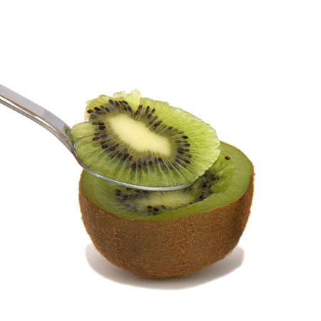 A halve of a kiwi and a spoonの写真素材